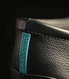 Close up of Tieks ballet flat cushioned heel and signature Tiek Blue stripe.